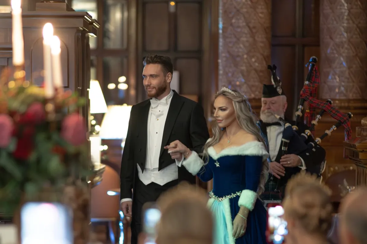 Guests in white tie in conversation on arrival at The Winter Banquet